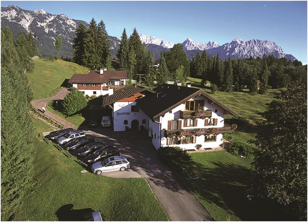 an aerial view of a house with cars parked in front at Gästehaus Alpina in Krün