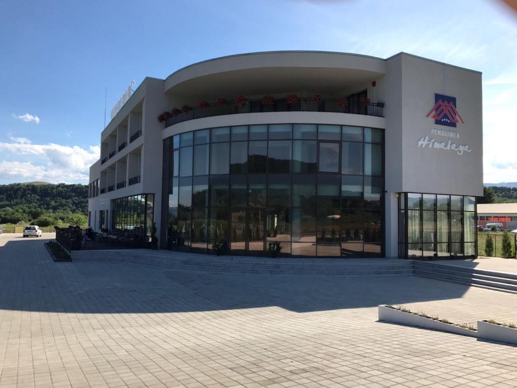 a large building with a lot of windows at Pensiunea Himalaya in Dărmăneasca