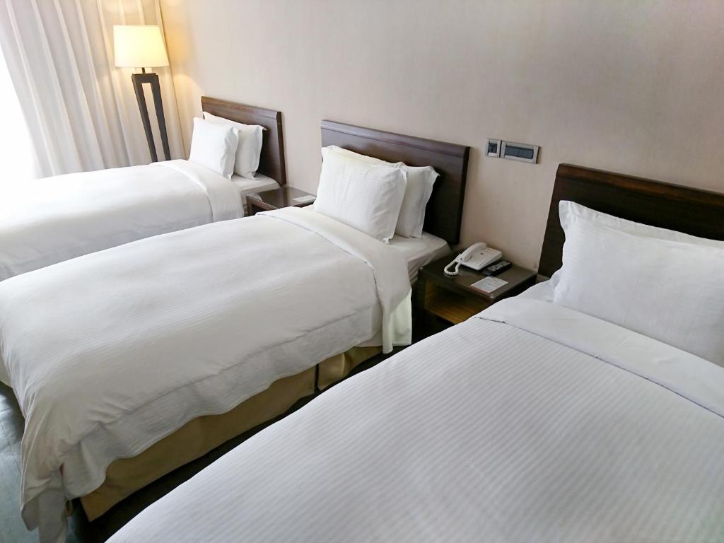 Postel nebo postele na pokoji v ubytování Century Hotel Taoyuan