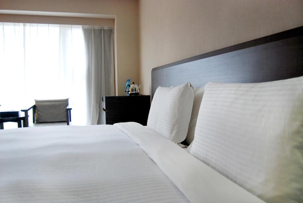 Postel nebo postele na pokoji v ubytování Century Hotel Taoyuan
