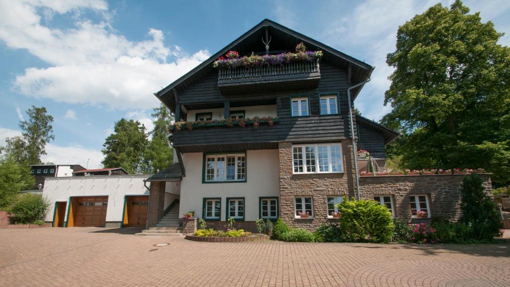 a house with a flower box on top of it at Schweizer Haus Wippra in Wippra