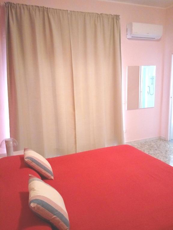 A bed or beds in a room at Michelangelo Rooms