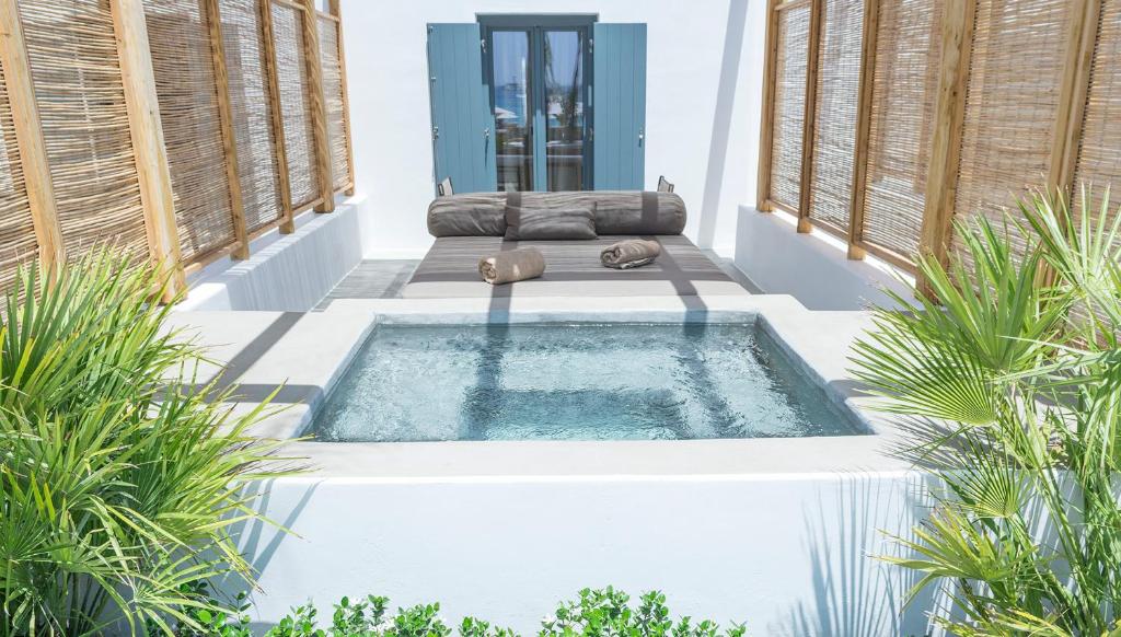 a swimming pool in the middle of a house at Branco Mykonos in Platis Gialos