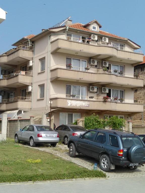 three cars parked in front of a building at Guest House D. Bogdanova in Obzor