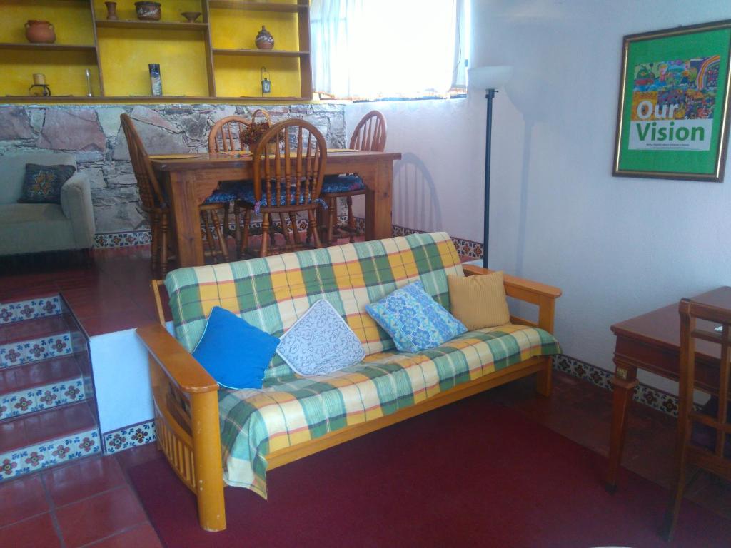 a living room with a couch with pillows on it at Arquitectos Departamento 12-1 in Guanajuato