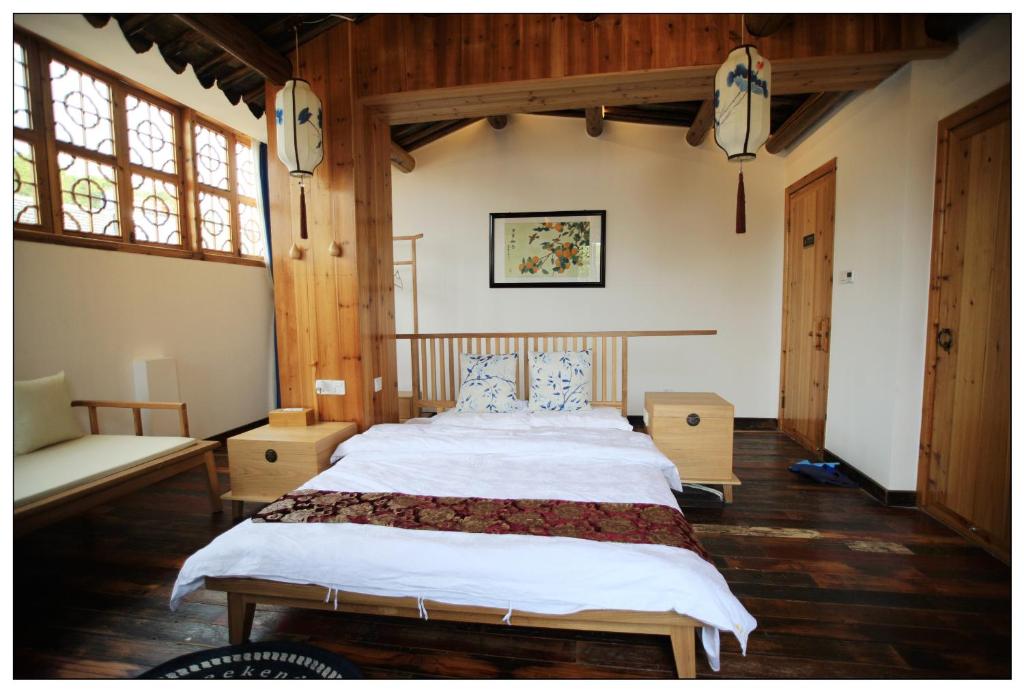 Postel nebo postele na pokoji v ubytování Begonia Flowers Guesthouse