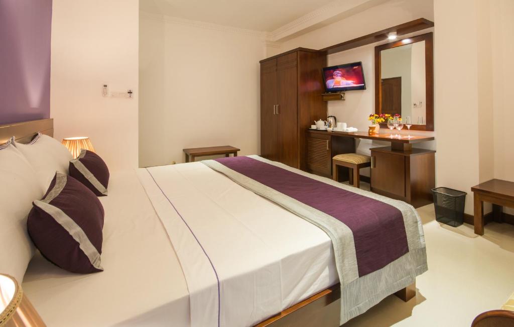 Postel nebo postele na pokoji v ubytování Ceyloni City Hotel
