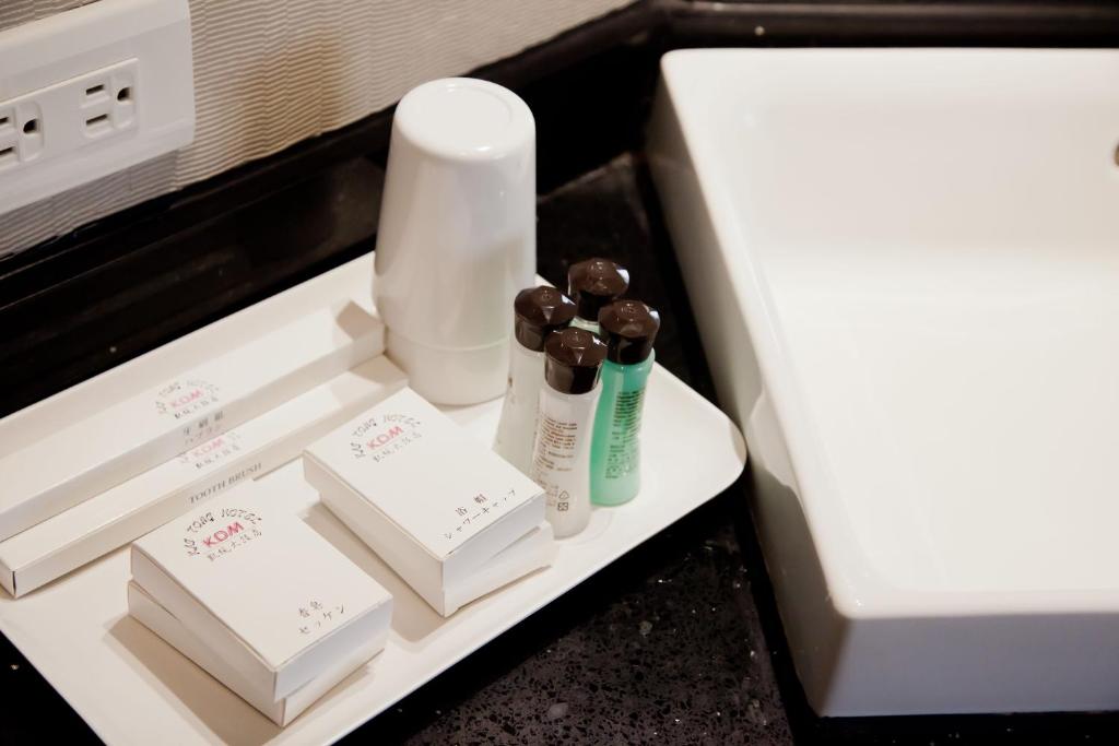 a drawer with two bottles of soap and a microwave at KDM Hotel in Taipei