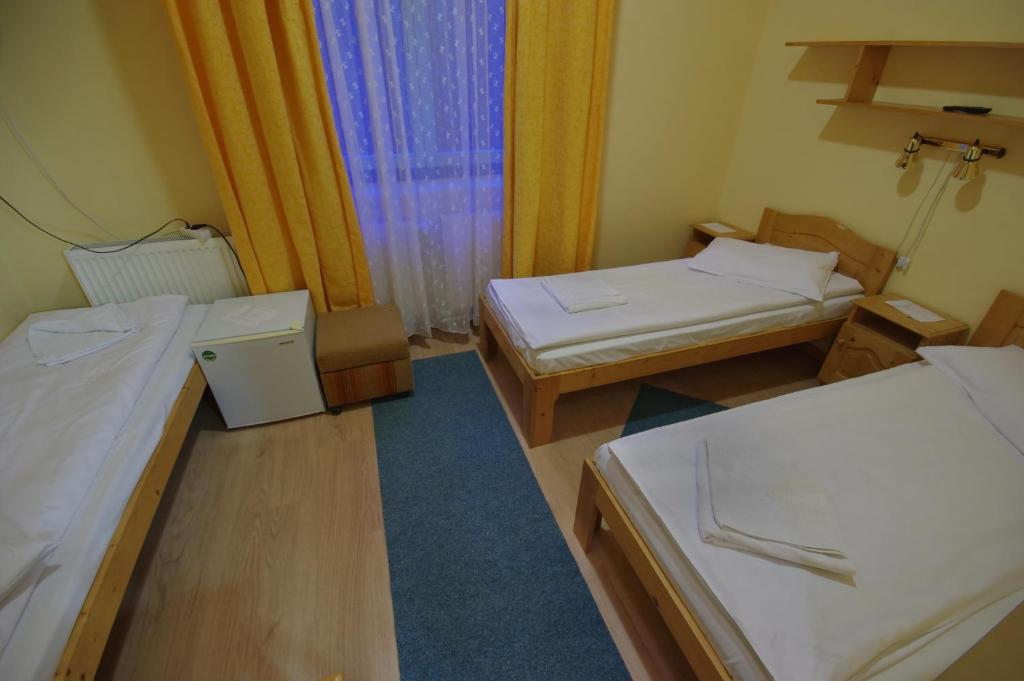 Postel nebo postele na pokoji v ubytování Hostel Teleki