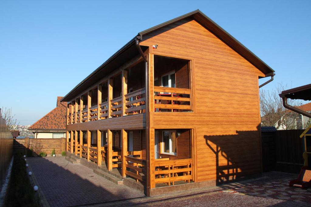 a large wooden house with a large window at Panorama Dofinovka in Nova Dofinivka