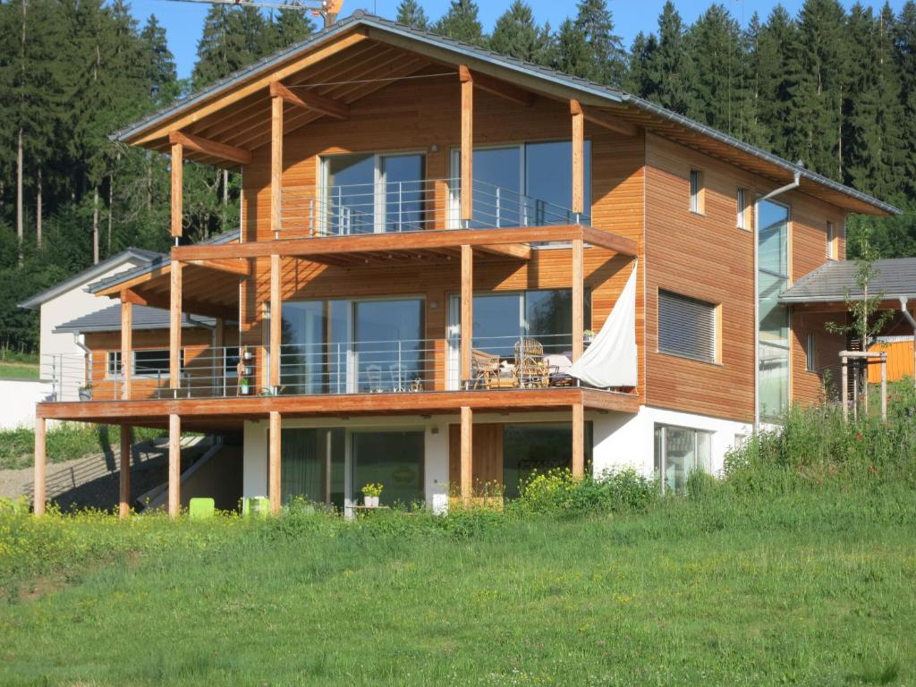 ein großes Holzhaus mit einer großen Terrasse in der Unterkunft ALLGÄU HAUS in Isny im Allgäu