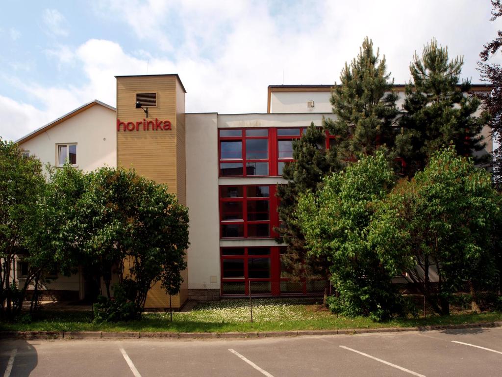 a building with a honda sign on the side of it at Penzion Horinka Velké Losiny in Velké Losiny