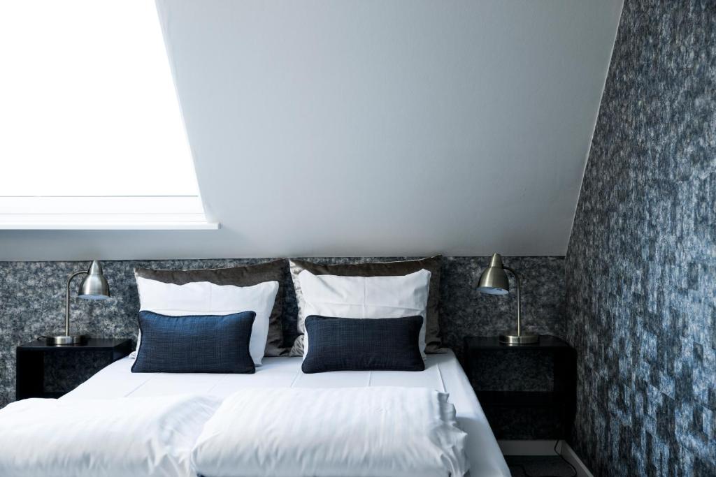 Postel nebo postele na pokoji v ubytování Skjalm Hvide Hotel