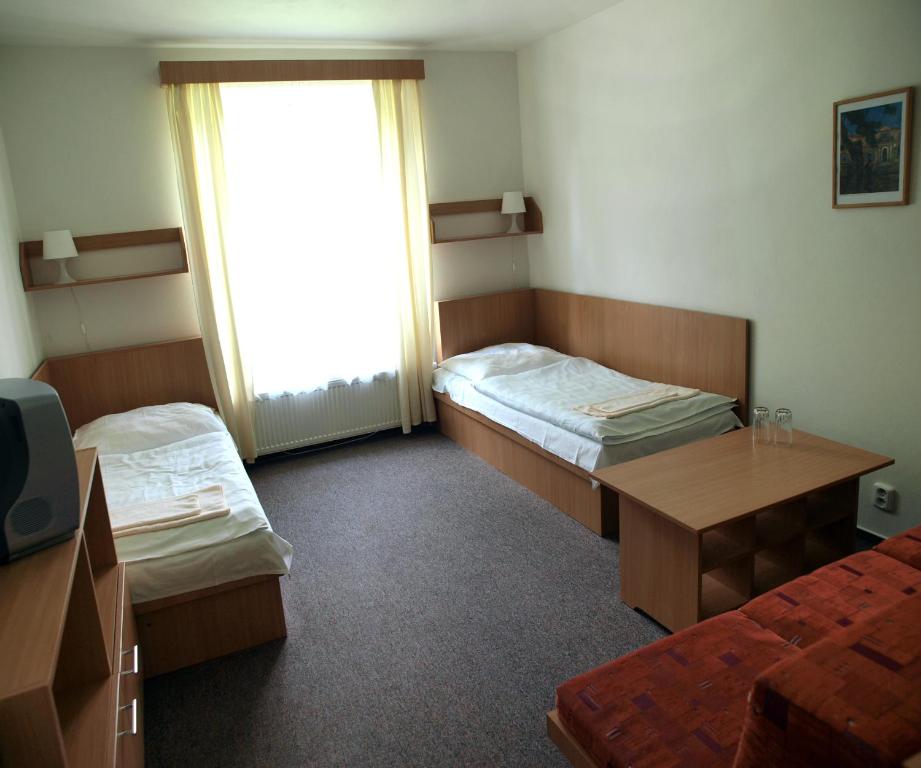 Postel nebo postele na pokoji v ubytování Penzion Horinka Velké Losiny
