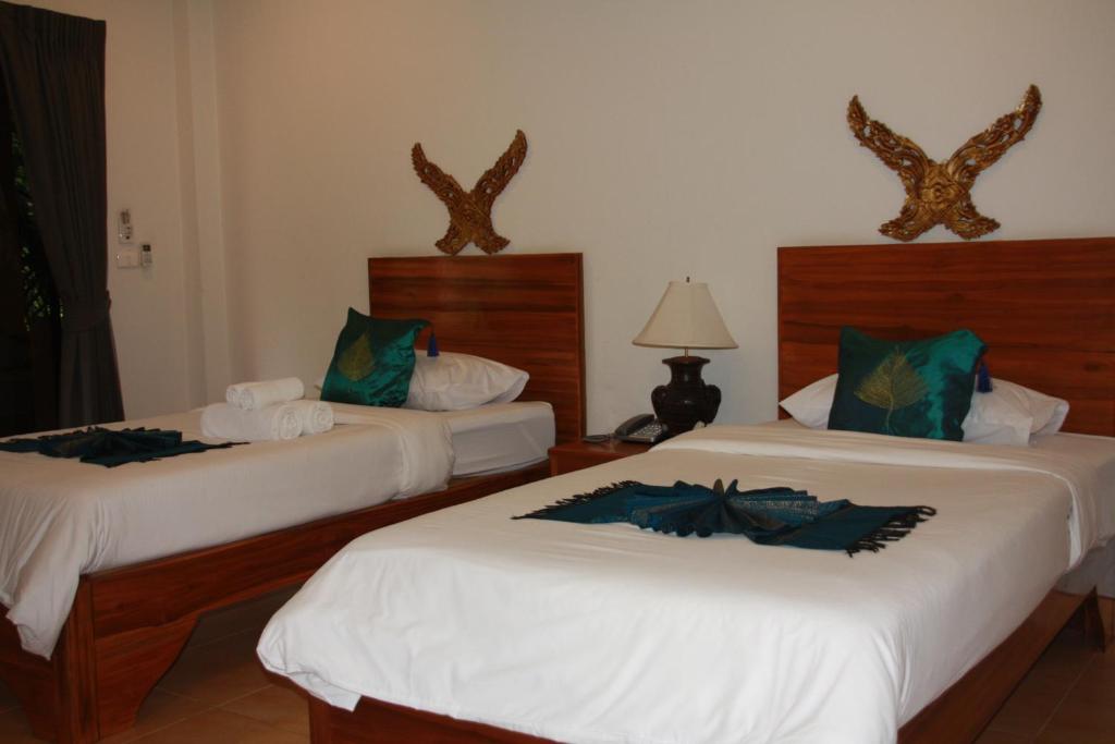 Postel nebo postele na pokoji v ubytování Baan Vanida Garden Resort