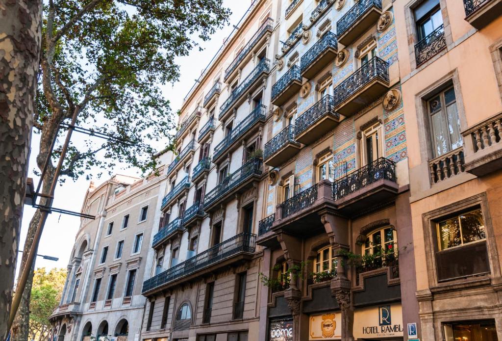 a row of buildings with balconies on a street at Ramblas Hotel in Barcelona