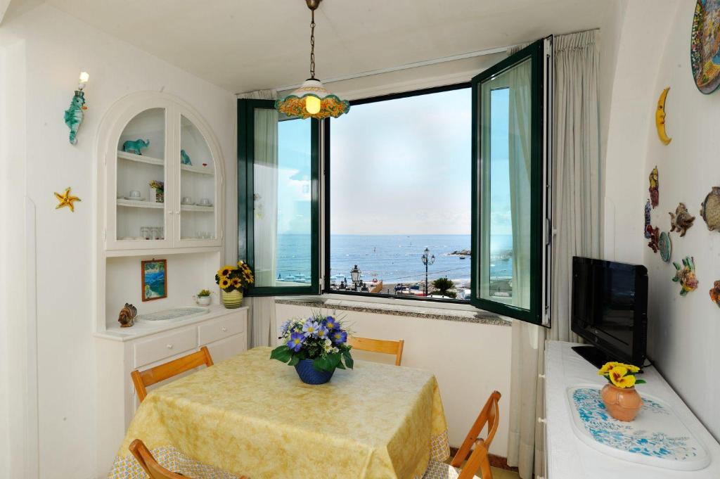 a dining room with a table and a view of the ocean at That's Atrani in Atrani