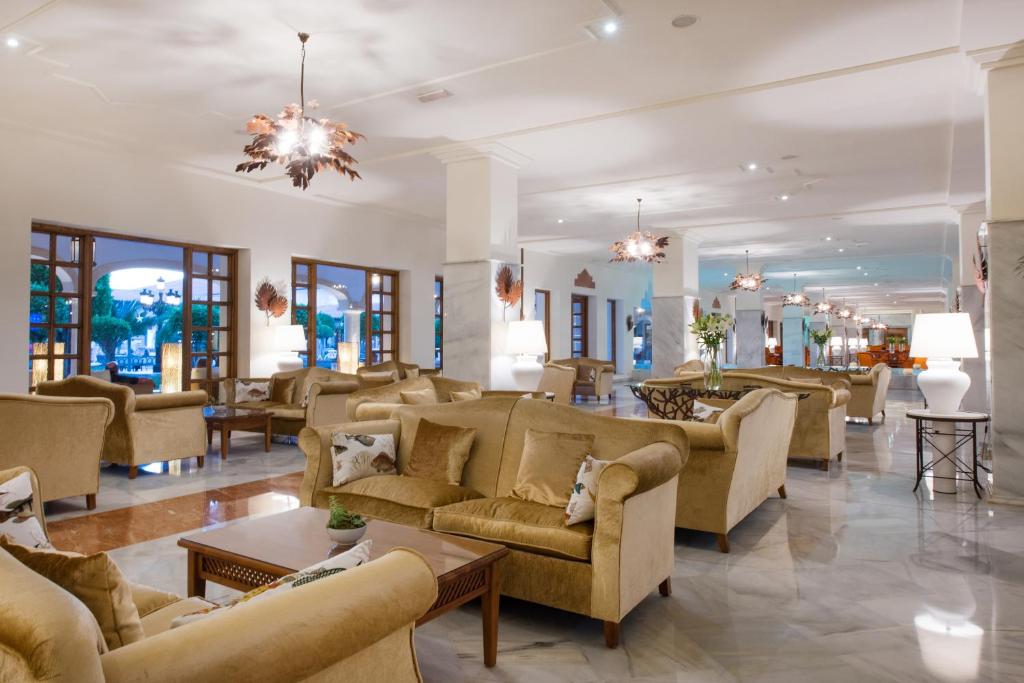 a large lobby with couches and tables and windows at Iberostar Selection Andalucia Playa in Chiclana de la Frontera