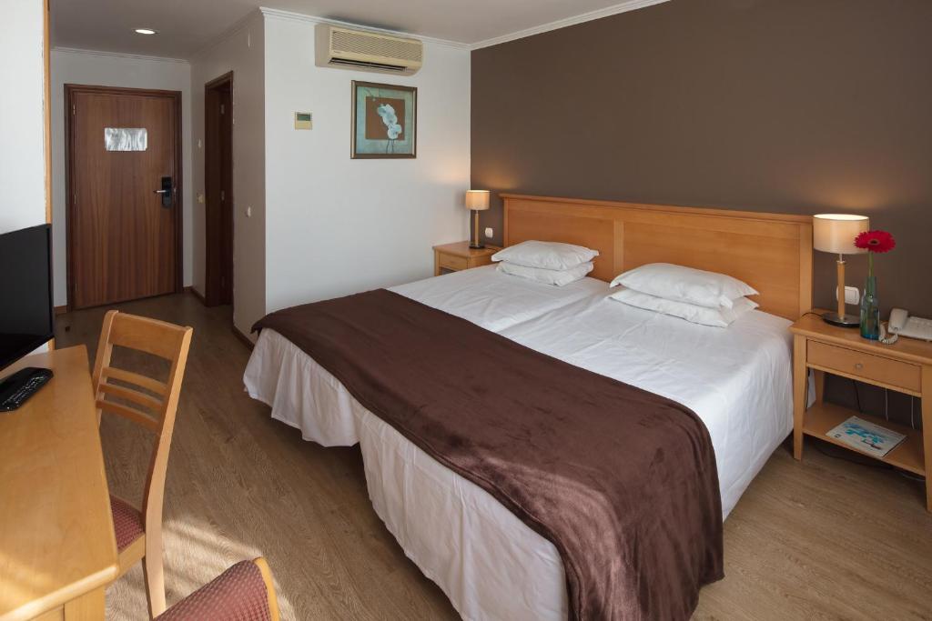 Postel nebo postele na pokoji v ubytování Hotel Orquidea