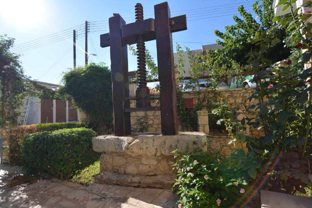a statue of a cross in a yard at Palates Hotel in Droushia