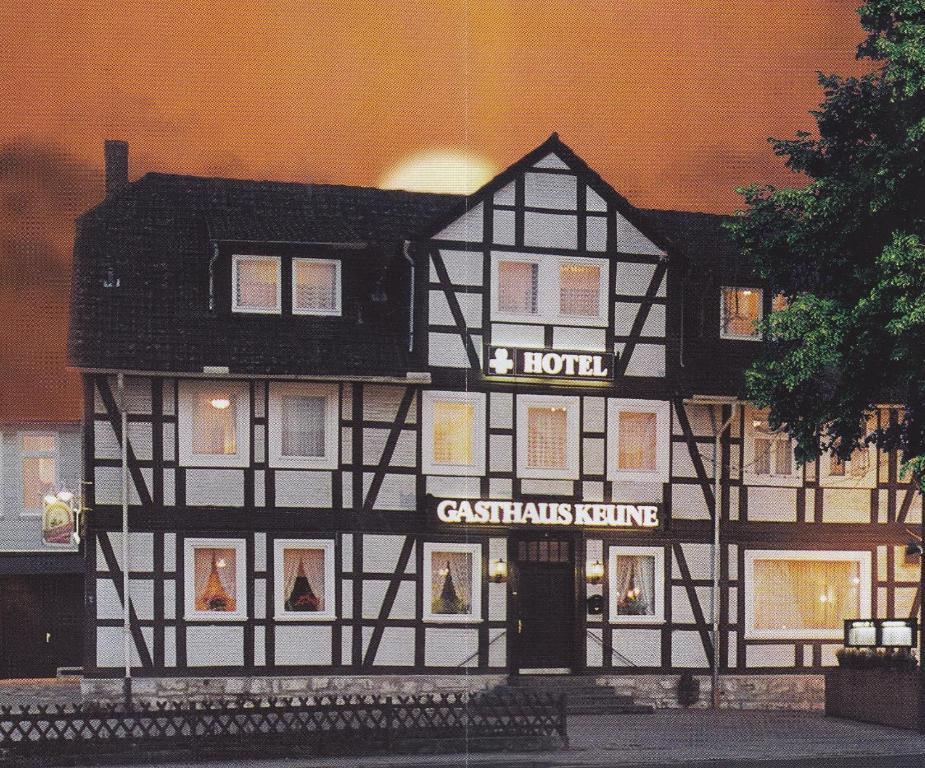 a black and white building with a christmas home at Hotel Gasthaus Keune in Salzgitter