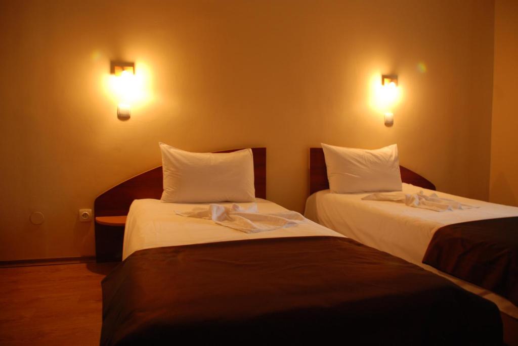 Postel nebo postele na pokoji v ubytování Hotel Liliacul