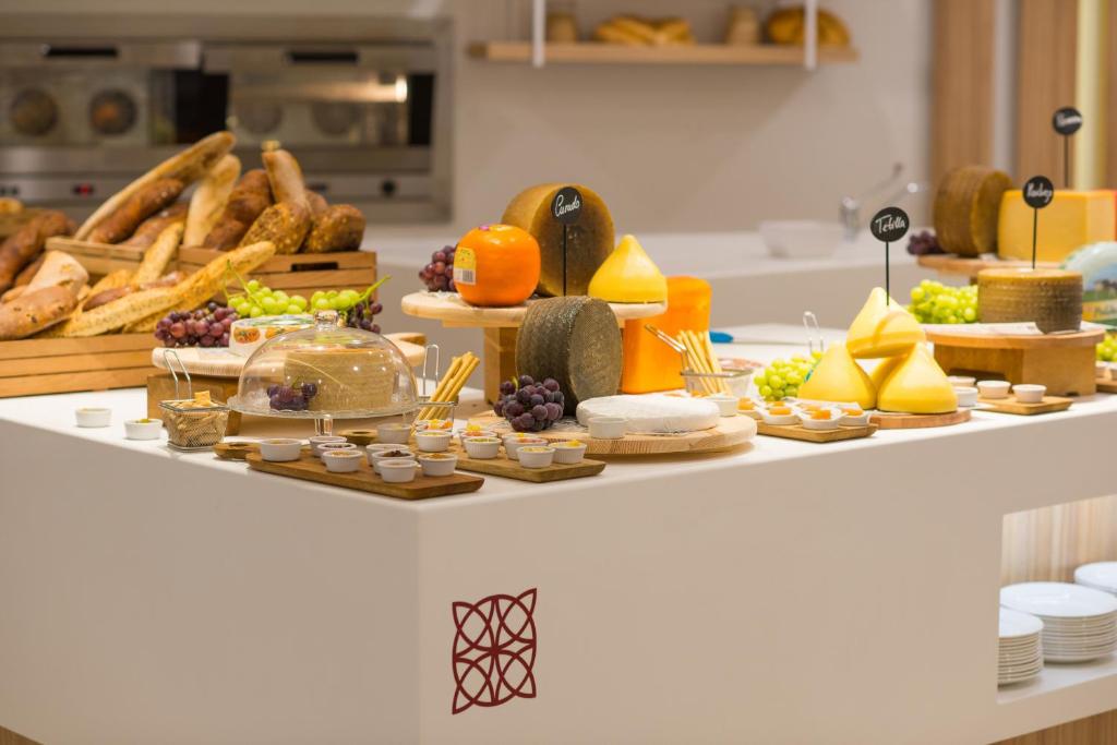 a buffet of food on a counter in a kitchen at Iberostar Selection Andalucia Playa in Chiclana de la Frontera