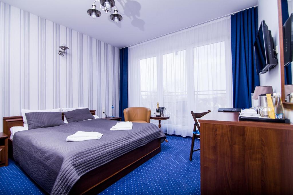 Postel nebo postele na pokoji v ubytování Hotel Jastarnia