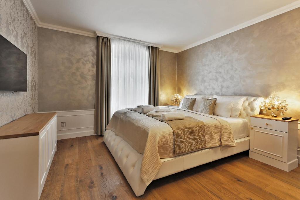 Postel nebo postele na pokoji v ubytování Wellness Hotel Republika 24 Apartments