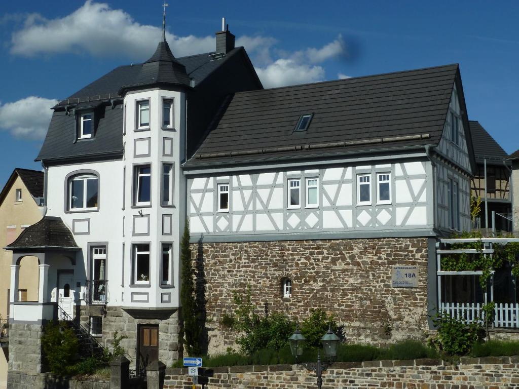 a large white building with a black roof at Apartments im Chateau d'Esprit in Höhr-Grenzhausen