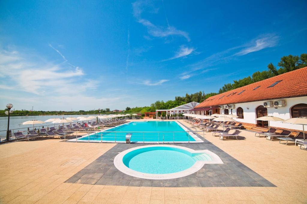 a large swimming pool next to a resort at Hotel Evergreen in Amara