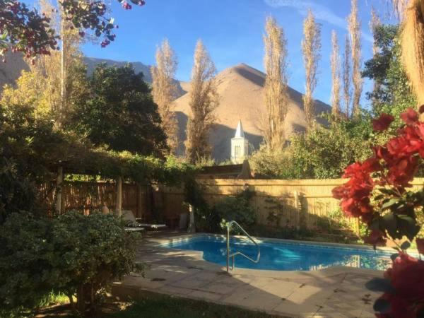 a swimming pool in a yard with a house at Pisco Elqui HolidayHome in Pisco Elqui