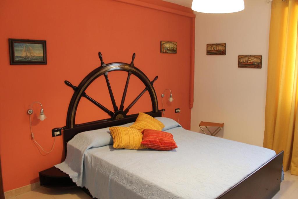 a bedroom with a bed with an orange wall at Capitan Nemo-Golfo dei Poeti in La Spezia