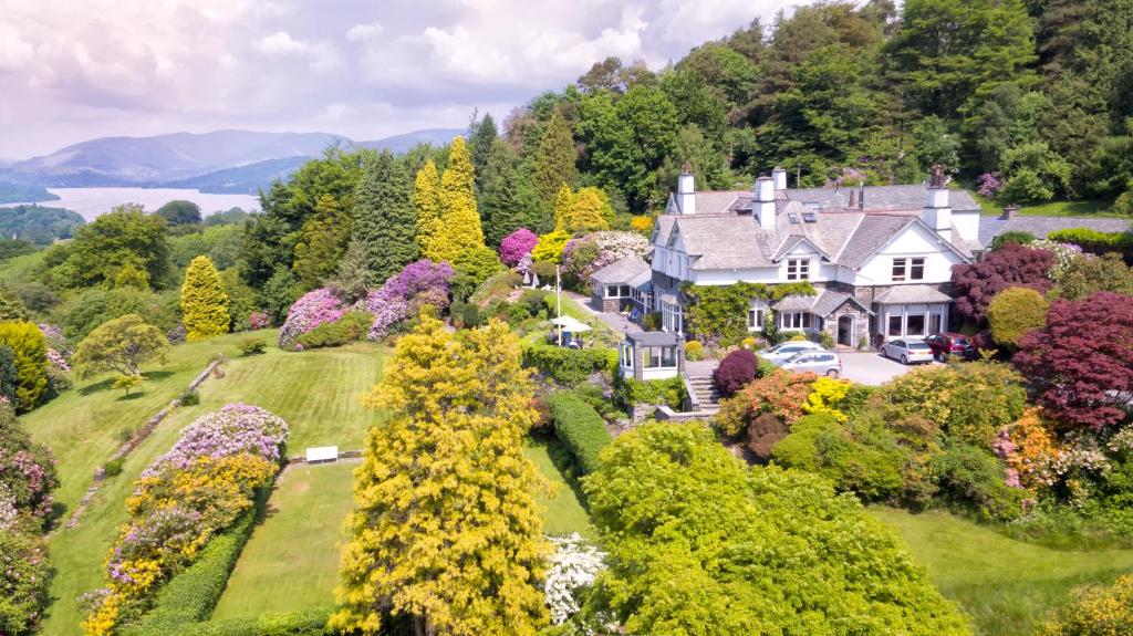 an aerial view of a house on a hill with trees at Lindeth Fell Country House in Bowness-on-Windermere