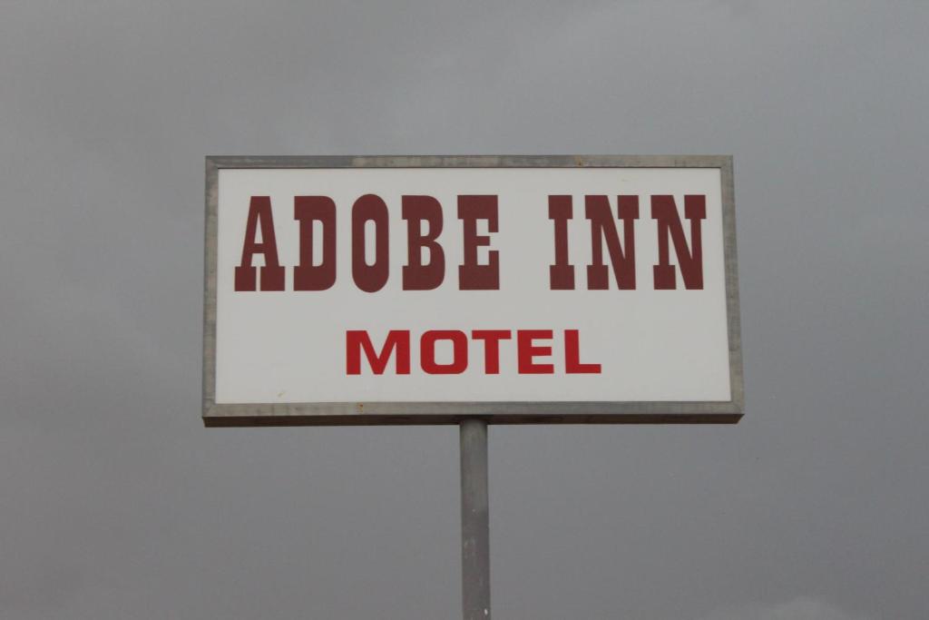 a sign that readsade im im im motel at Adobe Inn Motel in Clint