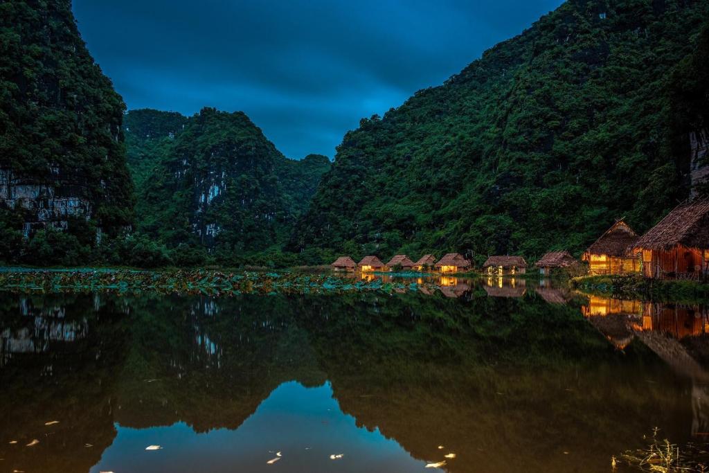 a view of a river with mountains in the background at Ninh Binh Valley Homestay in Ninh Binh