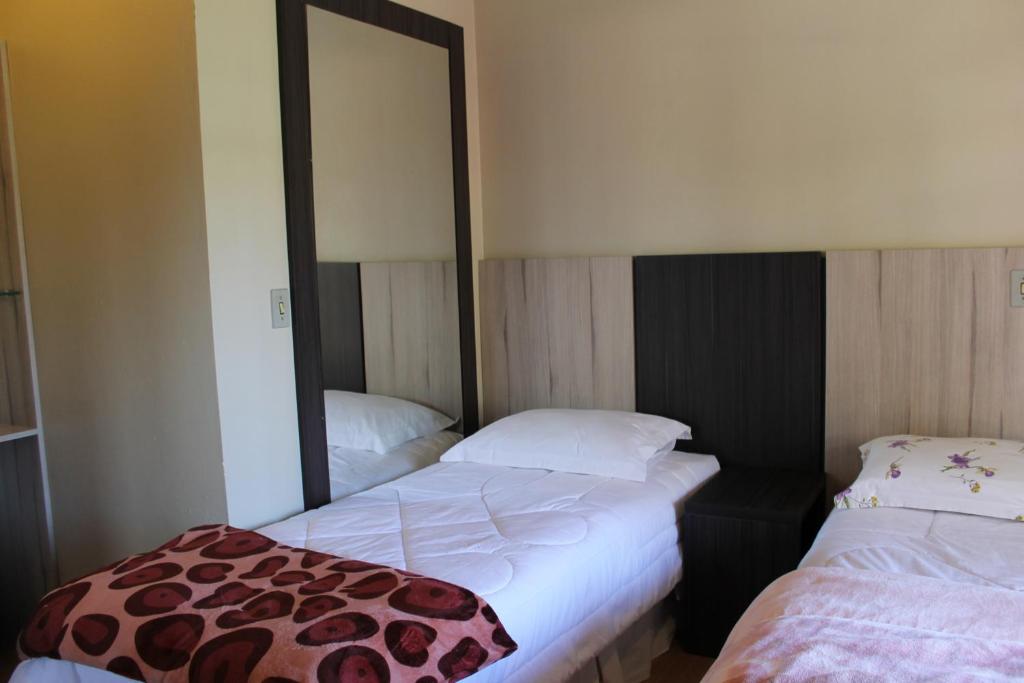 Postel nebo postele na pokoji v ubytování Residencial Aconchego do Lago