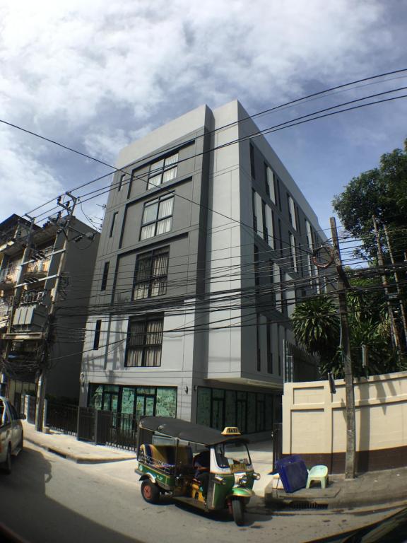 a green vehicle parked in front of a building at 28 Place in Bangkok