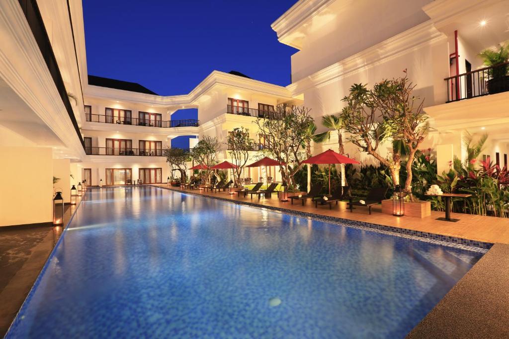 a swimming pool in the middle of a building at Grand Palace Hotel Sanur - Bali in Sanur