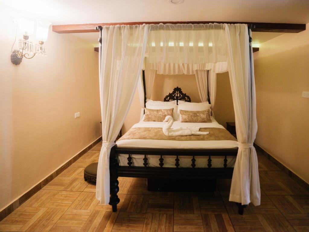 Postel nebo postele na pokoji v ubytování Casa Menezes - A Heritage Goan Homestay