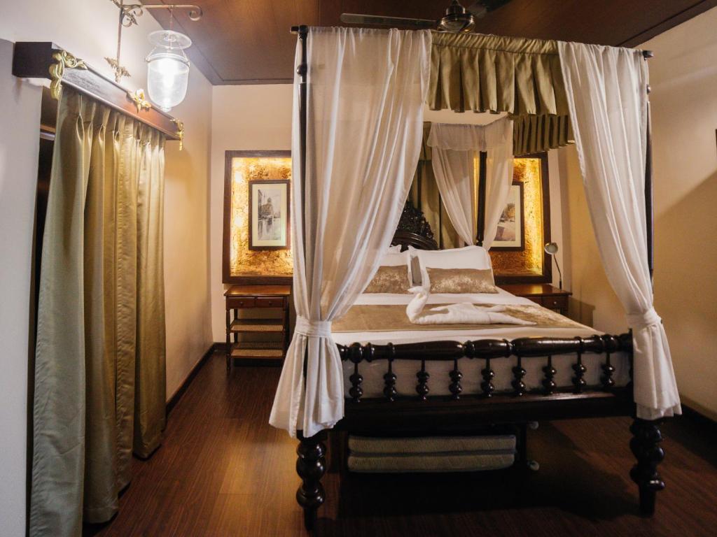 Postel nebo postele na pokoji v ubytování Casa Menezes - A Heritage Goan Homestay