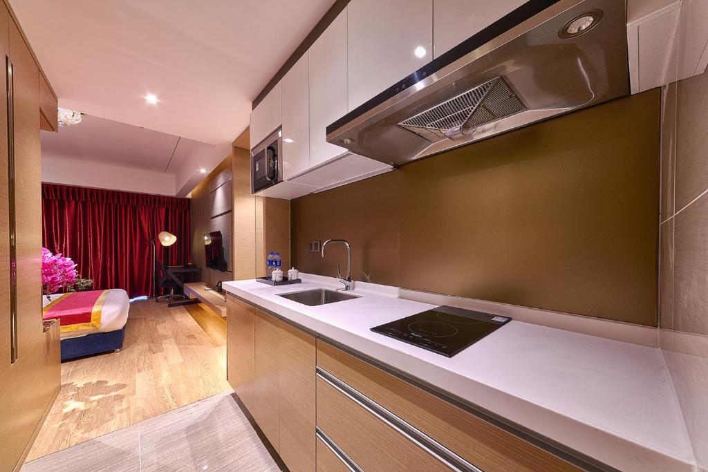 a kitchen with a sink and a stove at Heefun International Apartment - Zhujiang New Town FuLi Brand New World Plaza in Guangzhou