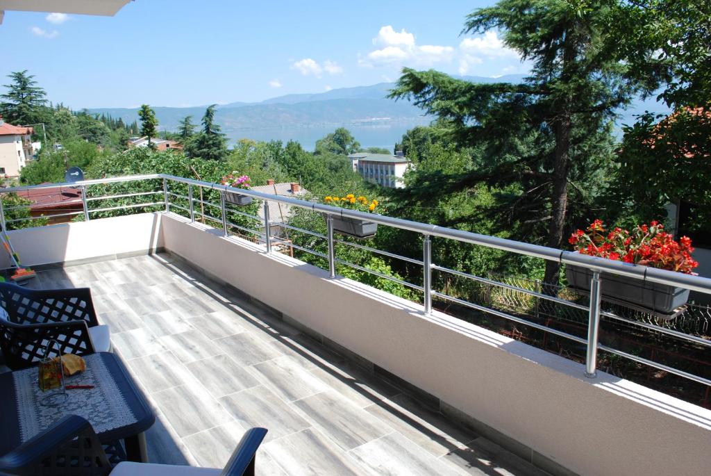 a balcony with a view of flowers and trees at Madzar Apartments in Star Dojran