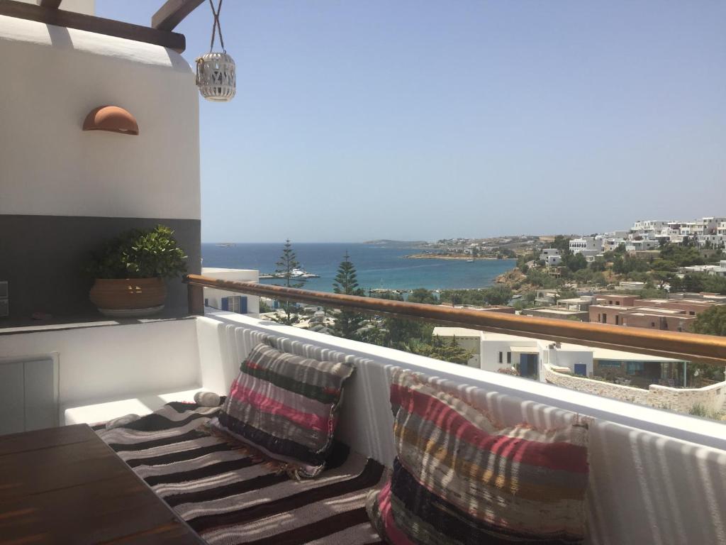 a balcony with two chairs and a view of the ocean at Anna's Studio in Piso Livadi