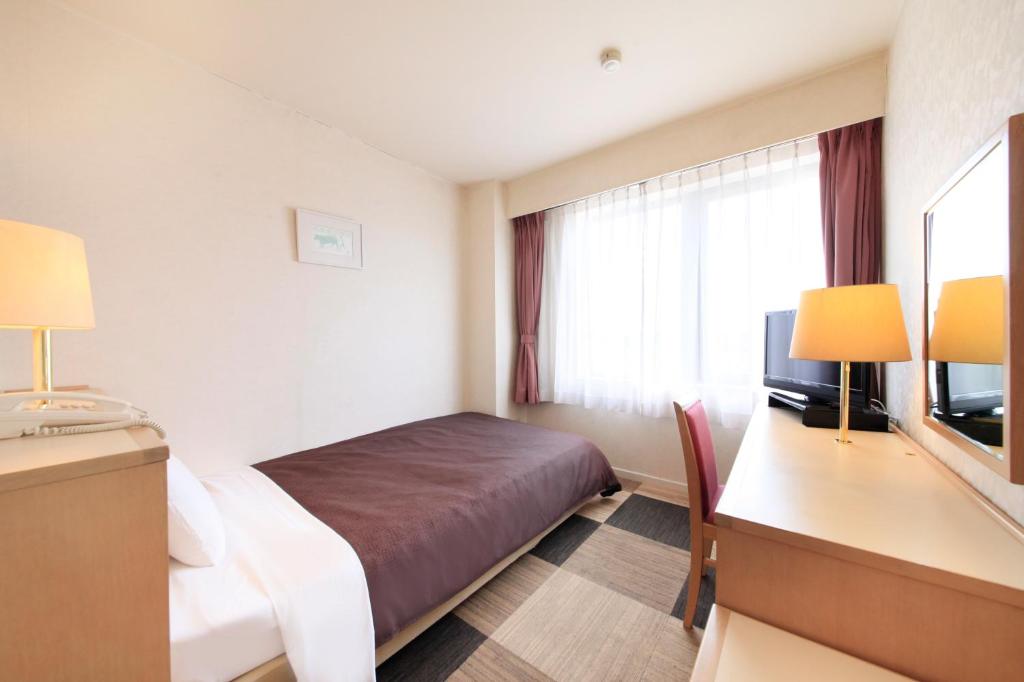 Postel nebo postele na pokoji v ubytování Quintessa Hotel Iseshima