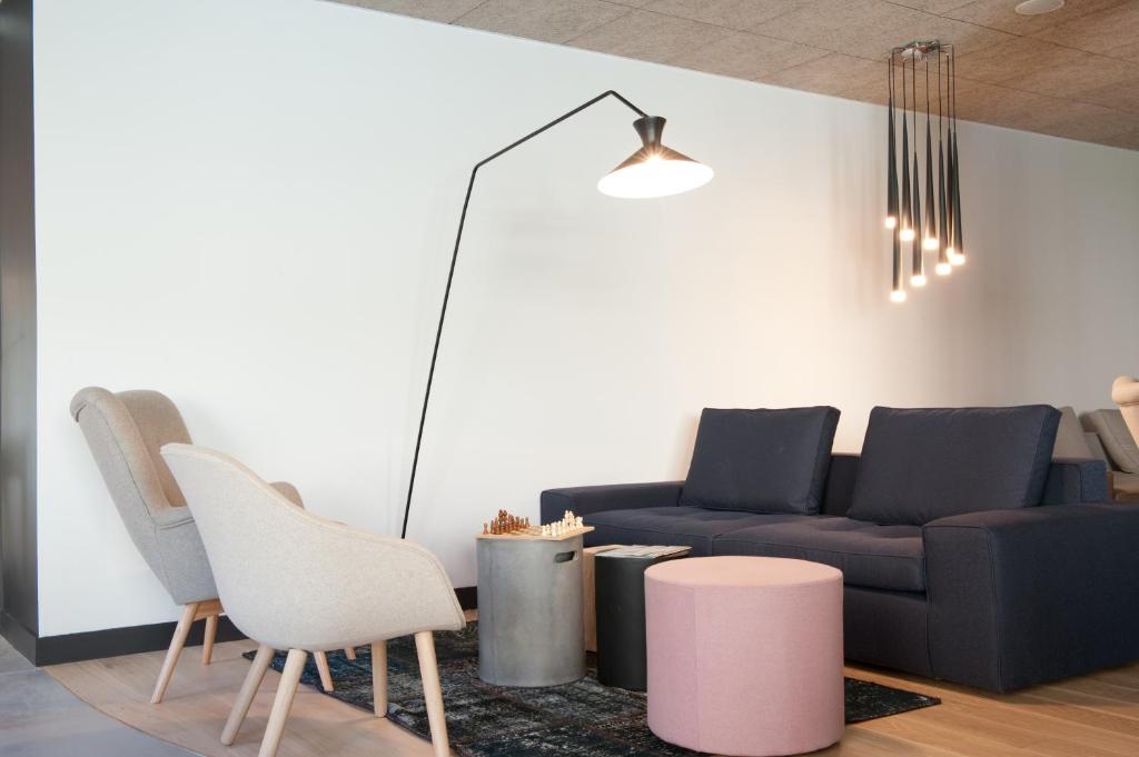 a living room with a couch and chairs at Campanile Limoges Centre - Gare in Limoges