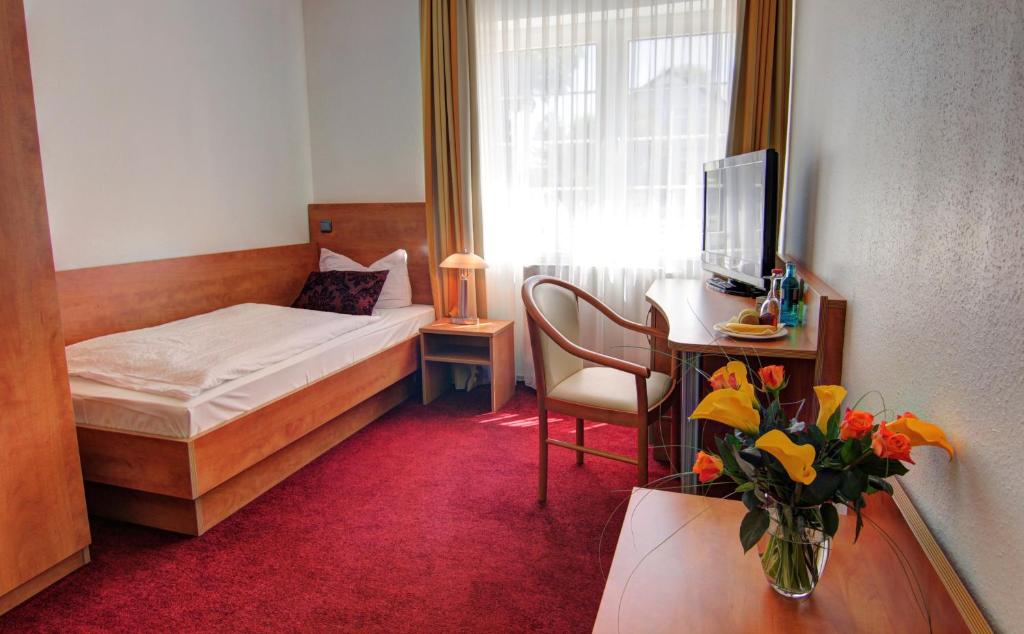 Postel nebo postele na pokoji v ubytování tauwerk Hotel