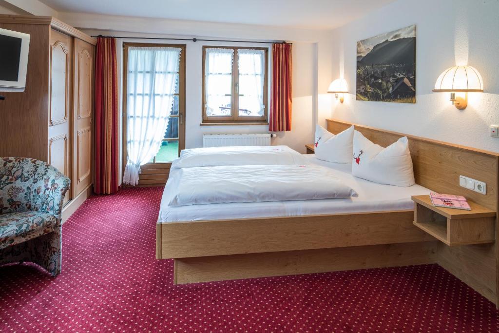 Postel nebo postele na pokoji v ubytování Gästehaus Walserheimat