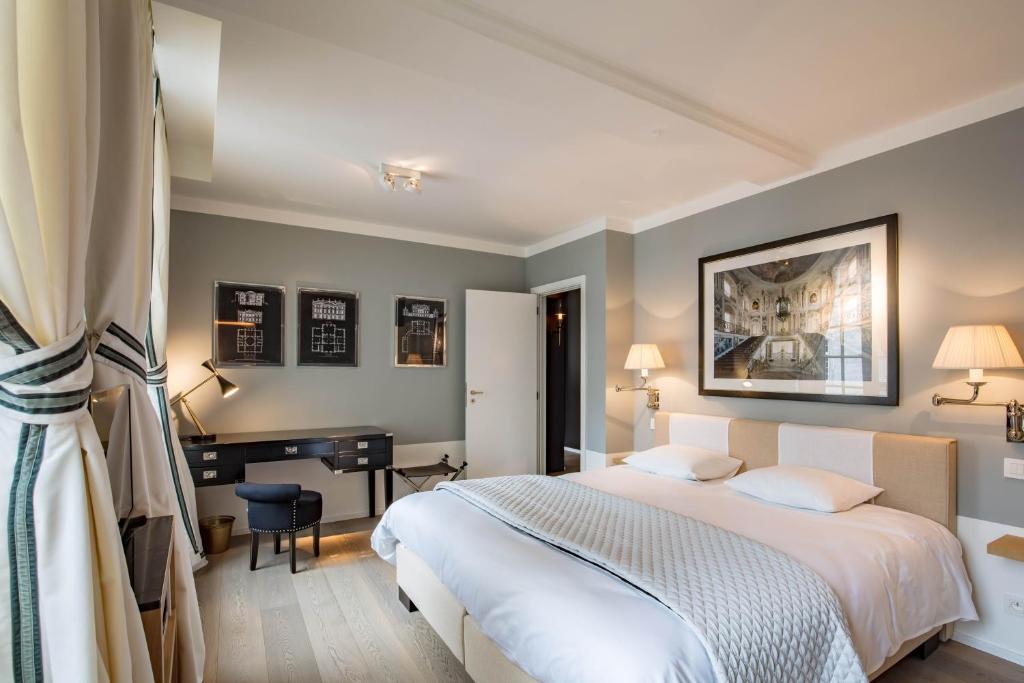 a hotel room with a bed and a desk at Faubourg Saint Martin in Liège