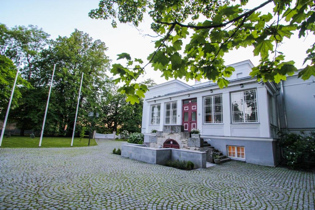 um edifício com uma porta vermelha e um pátio de tijolos em Saka Manor em Saka